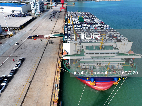 Roll-on wheels load export vehicles at the terminal of the Oriental Port Branch of Lianyungang Port in Lianyungang, China, on September 25,...