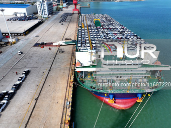 Roll-on wheels load export vehicles at the terminal of the Oriental Port Branch of Lianyungang Port in Lianyungang, China, on September 25,...