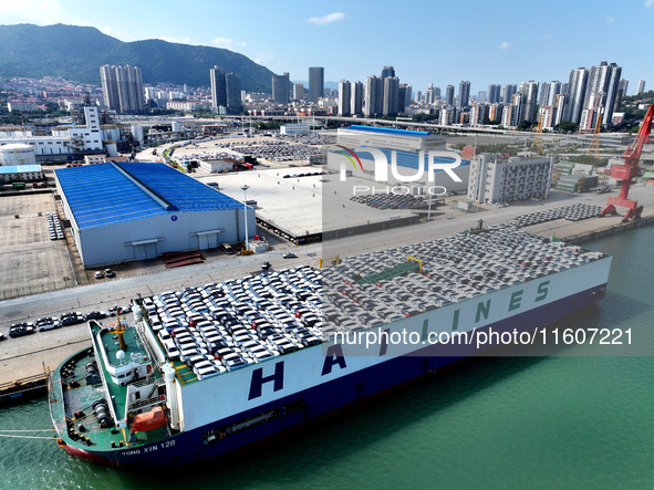 Roll-on wheels load export vehicles at the terminal of the Oriental Port Branch of Lianyungang Port in Lianyungang, China, on September 25,...