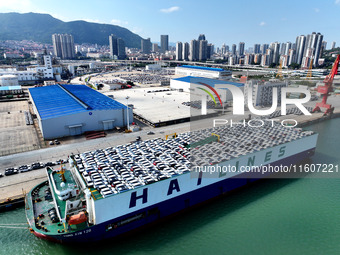 Roll-on wheels load export vehicles at the terminal of the Oriental Port Branch of Lianyungang Port in Lianyungang, China, on September 25,...