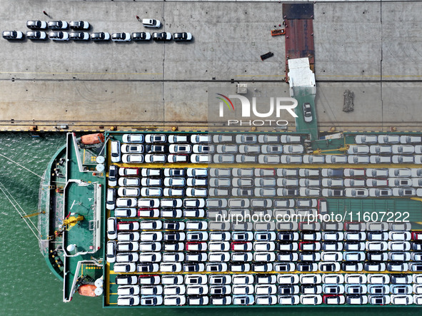 Roll-on wheels load export vehicles at the terminal of the Oriental Port Branch of Lianyungang Port in Lianyungang, China, on September 25,...