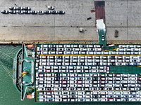 Roll-on wheels load export vehicles at the terminal of the Oriental Port Branch of Lianyungang Port in Lianyungang, China, on September 25,...