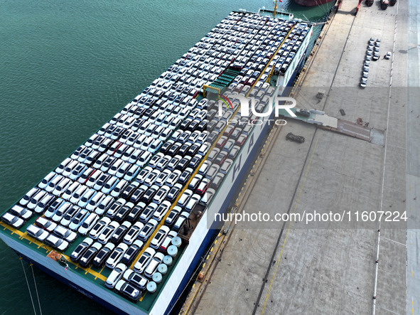 Roll-on wheels load export vehicles at the terminal of the Oriental Port Branch of Lianyungang Port in Lianyungang, China, on September 25,...