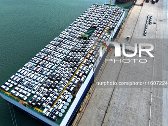 Roll-on wheels load export vehicles at the terminal of the Oriental Port Branch of Lianyungang Port in Lianyungang, China, on September 25,...