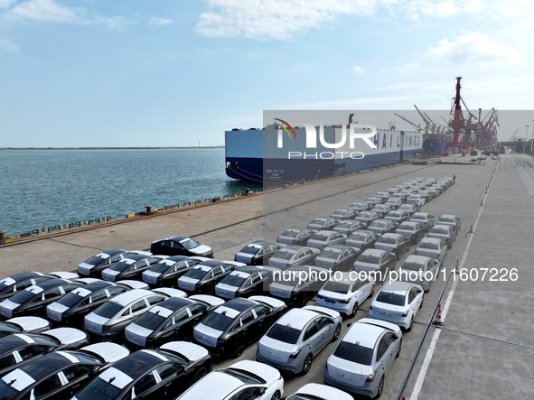 Roll-on wheels load export vehicles at the terminal of the Oriental Port Branch of Lianyungang Port in Lianyungang, China, on September 25,...