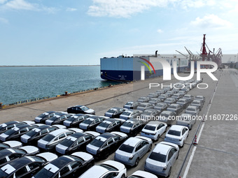 Roll-on wheels load export vehicles at the terminal of the Oriental Port Branch of Lianyungang Port in Lianyungang, China, on September 25,...