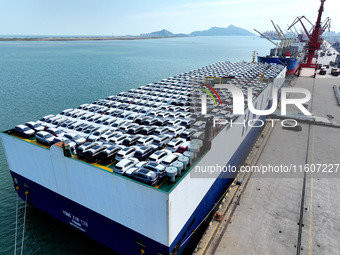 Roll-on wheels load export vehicles at the terminal of the Oriental Port Branch of Lianyungang Port in Lianyungang, China, on September 25,...