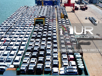 Roll-on wheels load export vehicles at the terminal of the Oriental Port Branch of Lianyungang Port in Lianyungang, China, on September 25,...