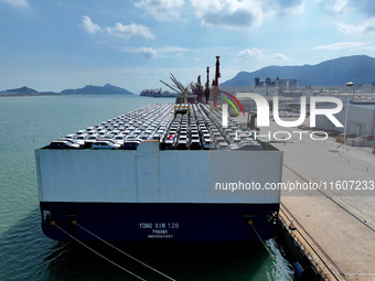 Roll-on wheels load export vehicles at the terminal of the Oriental Port Branch of Lianyungang Port in Lianyungang, China, on September 25,...