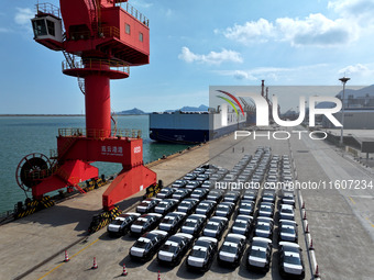 Roll-on wheels load export vehicles at the terminal of the Oriental Port Branch of Lianyungang Port in Lianyungang, China, on September 25,...