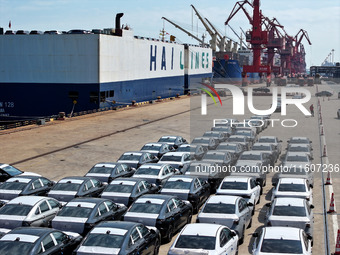 Roll-on wheels load export vehicles at the terminal of the Oriental Port Branch of Lianyungang Port in Lianyungang, China, on September 25,...