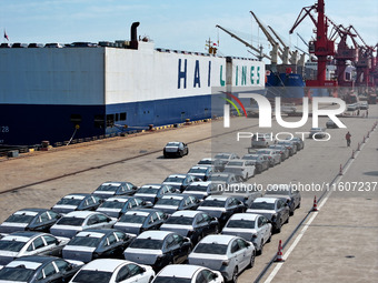 Roll-on wheels load export vehicles at the terminal of the Oriental Port Branch of Lianyungang Port in Lianyungang, China, on September 25,...