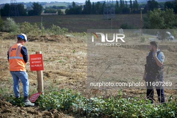 An NGE/Atosca worker places a placard reading 'construction site forbidden to public' under gendarmes' protection. For the fifth day, the Ge...