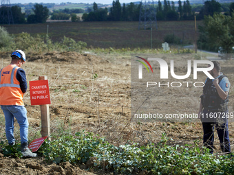 An NGE/Atosca worker places a placard reading 'construction site forbidden to public' under gendarmes' protection. For the fifth day, the Ge...