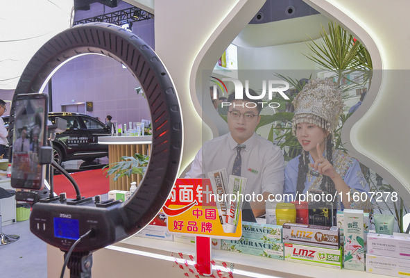 A merchant sells goods via a live webcast at the 21st China-Asean Expo in Nanning, China, on September 25, 2024. 