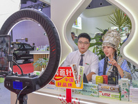 A merchant sells goods via a live webcast at the 21st China-Asean Expo in Nanning, China, on September 25, 2024. (