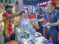 Visitors buy cultural and creative goods at the Ugandan stand at the 21st China-Asean Expo in Nanning, Guangxi Zhuang Autonomous Region, Chi...