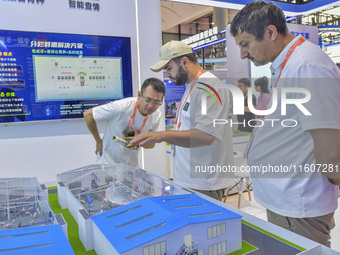 Uzbek businessmen learn to raise pigs at the 21st China-Asean Expo in Nanning, China, on September 25, 2024. (