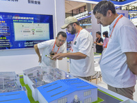 Uzbek businessmen learn to raise pigs at the 21st China-Asean Expo in Nanning, China, on September 25, 2024. (