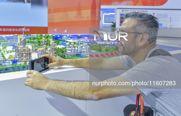 Foreign businessmen visit the stand of China Energy Group at the 21st China-Asean Expo in Nanning, China, on September 25, 2024. 