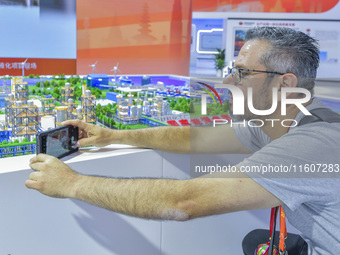 Foreign businessmen visit the stand of China Energy Group at the 21st China-Asean Expo in Nanning, China, on September 25, 2024. (