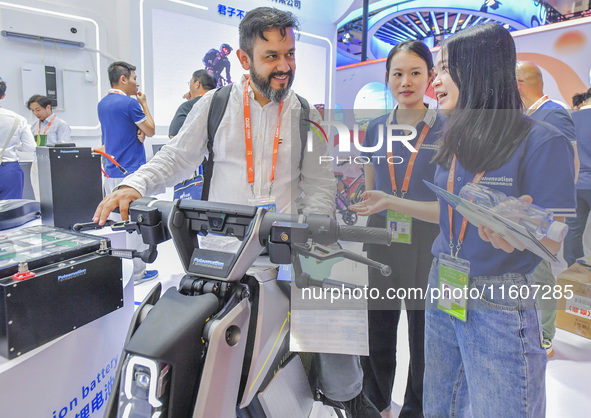 Foreign businessmen visit the stand of China Energy Group at the 21st China-Asean Expo in Nanning, China, on September 25, 2024. 