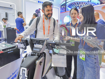 Foreign businessmen visit the stand of China Energy Group at the 21st China-Asean Expo in Nanning, China, on September 25, 2024. (