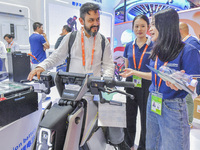 Foreign businessmen visit the stand of China Energy Group at the 21st China-Asean Expo in Nanning, China, on September 25, 2024. (