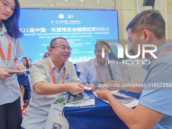 Businessmen exchange views at the 21st China-Asean Expo in Nanning, China, on September 25, 2024. (