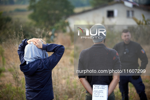 People watch as Atosca buries the 'Verger' house under soil. For the fifth day, Gendarmerie and CNAMO try to dislodge 'Ecureuils' (i.e., 'Sq...