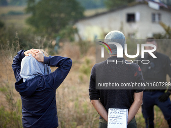 People watch as Atosca buries the 'Verger' house under soil. For the fifth day, Gendarmerie and CNAMO try to dislodge 'Ecureuils' (i.e., 'Sq...