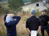 People watch as Atosca buries the 'Verger' house under soil. For the fifth day, Gendarmerie and CNAMO try to dislodge 'Ecureuils' (i.e., 'Sq...