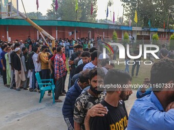 Voters queue to cast their ballots at a polling station during the second phase of assembly elections in Srinagar, Jammu and Kashmir, on Sep...