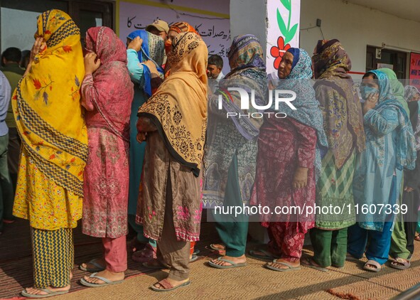 Women voters queue to cast their ballots at a polling station during the second phase of assembly elections in Srinagar, Jammu and Kashmir,...