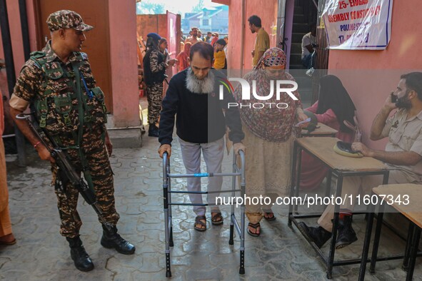 A handicapped man arrives to cast his ballot at a polling station during the second phase of assembly elections in Srinagar, Jammu and Kashm...