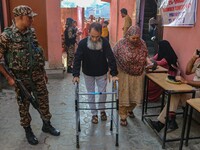 A handicapped man arrives to cast his ballot at a polling station during the second phase of assembly elections in Srinagar, Jammu and Kashm...