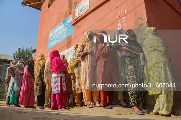 Women voters queue to cast their ballots at a polling station during the second phase of assembly elections in Srinagar, Jammu and Kashmir,...