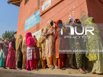 Women voters queue to cast their ballots at a polling station during the second phase of assembly elections in Srinagar, Jammu and Kashmir,...