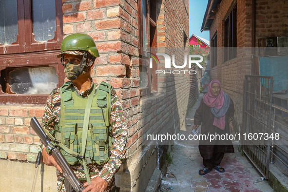 An elderly woman arrives to cast her ballot at a polling station during the second phase of assembly elections in Srinagar, Jammu and Kashmi...