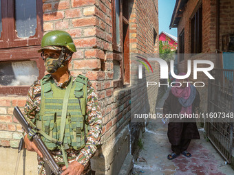 An elderly woman arrives to cast her ballot at a polling station during the second phase of assembly elections in Srinagar, Jammu and Kashmi...