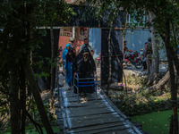 A handicapped woman arrives to cast her ballot at a polling station during the second phase of assembly elections in Srinagar, Jammu and Kas...