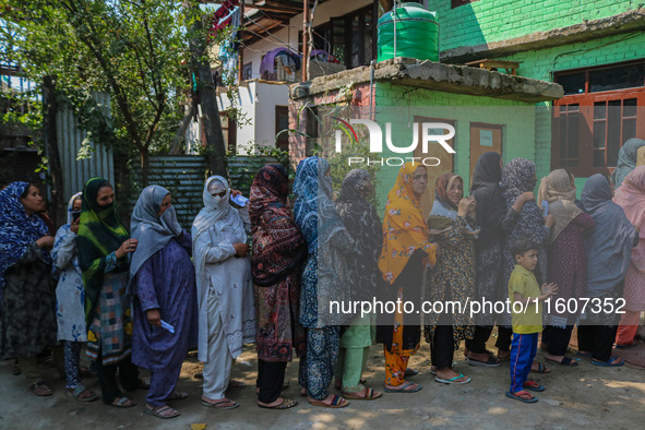 Women voters queue to cast their ballots at a polling station during the second phase of assembly elections in Srinagar, Jammu and Kashmir,...