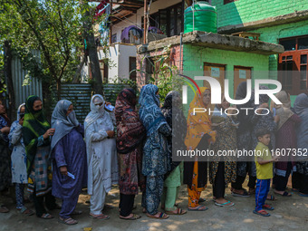 Women voters queue to cast their ballots at a polling station during the second phase of assembly elections in Srinagar, Jammu and Kashmir,...