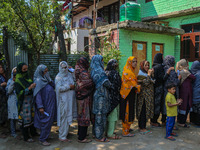 Women voters queue to cast their ballots at a polling station during the second phase of assembly elections in Srinagar, Jammu and Kashmir,...