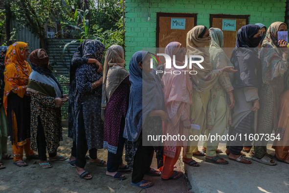 Women voters queue to cast their ballots at a polling station during the second phase of assembly elections in Srinagar, Jammu and Kashmir,...