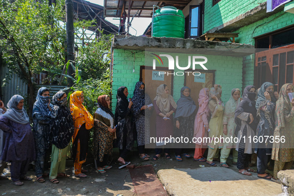 Women voters queue to cast their ballots at a polling station during the second phase of assembly elections in Srinagar, Jammu and Kashmir,...