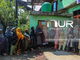 Women voters queue to cast their ballots at a polling station during the second phase of assembly elections in Srinagar, Jammu and Kashmir,...