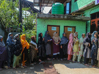 Women voters queue to cast their ballots at a polling station during the second phase of assembly elections in Srinagar, Jammu and Kashmir,...