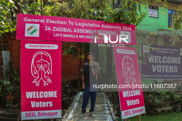 A man shows his ink-marked finger after casting his ballot at a polling station during the second phase of assembly elections in Srinagar, J...