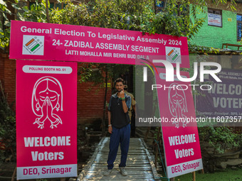 A man shows his ink-marked finger after casting his ballot at a polling station during the second phase of assembly elections in Srinagar, J...